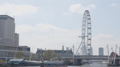 View-From-Boat-On-River-Thames-Going-Under-Waterloo-Bridge-Showing-London-Eye-And-Houses-Of-Parliament